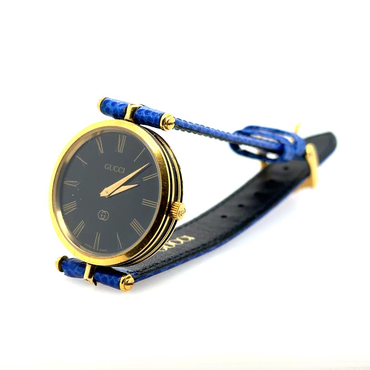 Gucci Watch - Blue Strap Gold-Tone Case Roman Numerals